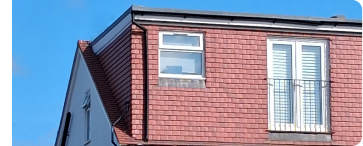 Flat roof dormer loft conversion on a red-brick house