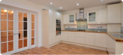 Open-plan kitchen diner with French doors and wood flooring