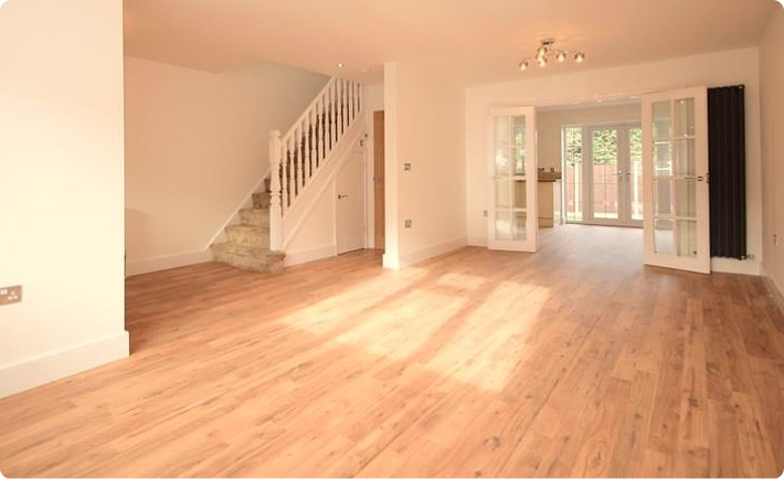 Newly laid wood-effect flooring in an open-plan room